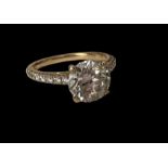 A 2.25ct diamond and 18ct yellow gold ring with diamond set shoulders and 4 claw setting.