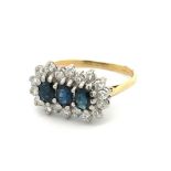 A sapphire and diamond triple cluster ring. 18ct yellow gold shank with 18ct white gold gallery