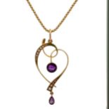 An Edwardian art nouveau amethyst and seed pearl pendant with chain. Pendant stamped 15ct