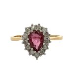 A pear cut ruby and diamond cluster ring, hallmarked 18ct. Ruby 6.5mm x 5mm. Estimated diamond