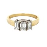 An 18ct gold and octagonal cut three stone diamond ring. Central diamond approx. 0.56ct