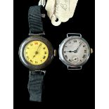 Pair of small silver manual wind trench watches, one with yellow dial and black Roman numerals (12