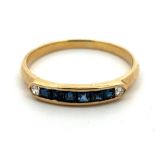 An 18ct gold, channel set sapphire and diamond ring, stamped 750. Size K. weight 1.39g.