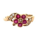 A 9ct ruby and seed pearl flower ring with diamond set shoulders. Size P. Weight 2.43g. Birmingham