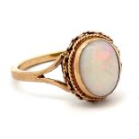 An opal ring in 9ct gold with rope twist surround. Birmingham hallamrks. Size P. Total weight 3.03g.