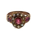 Georgian garnet and split pearl ring with garnet shoulders. Rose toned metal shank. See photos for