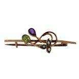 A peridot, amethyst and seed pearl bar brooch, stamped 9ct, 4cm in length. Weight 2.2g