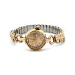 Tudor 18ct gold cased ladies wristwatch with Rolex crown on a gold coloured expandable bracelet.
