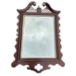 18th Century mahogany wall mirror with broken swan's neck pediment and attractive trellis work,