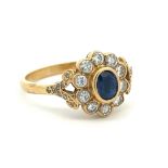 An early 20th Century 18ct yellow gold, sapphire and diamond cluster ring. Sapphire approx 5.5mm x