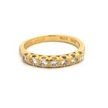 An 18ct gold seven stone diamond ring. Total diamond weight approx 0.21ct. Size M, weight 3.16g.