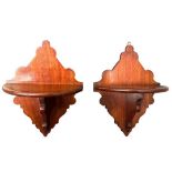 A pair of decorative late 19th Century mahogany wall brackets, height 25.5cm and width 19.5cm.