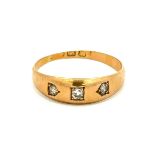 An 18ct gold gypsy ring set with three old cut diamonds. Central diamond approx 2.5mm diameter.