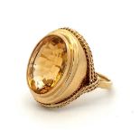 A gold and citrine dress ring with rope twist surround. Size P. Citrine approx 16 x 12mm. Engraved