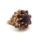 A garnet cluster ring set in 9ct gold, Birmingham hallmarks. Size N. Weight 7.58g. Please see the