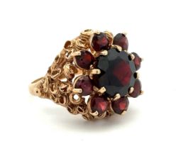 A garnet cluster ring set in 9ct gold, Birmingham hallmarks. Size N. Weight 7.58g. Please see the