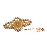 A yellow metal seed pearl and diamond brooch. Length 36mm. Weight 5.63g. Please see the buyer's
