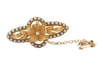 A yellow metal seed pearl and diamond brooch. Length 36mm. Weight 5.63g. Please see the buyer's