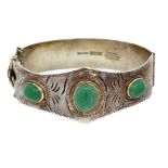 A silver hinged bangle set with three aventurine quartzes. Birmingham hallmarks. Please see the