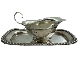 A silver cream jug and tray. Cream jug, 15cm in length, by S Lesser & Sons Ltd, Birmingham 1929.