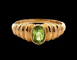 An oval peridot 9ct gold ring, size Q. Weight 2.58g. Please see the buyer's terms and conditions for