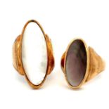 Two 9ct gold rings set with shell / mother of pearl, both size Q. Larger ring 31mm in length,