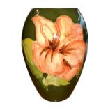 Moorcroft – A Moorcroft Hibiscus pattern small vase, stamped Moorcroft to base. Height 13.5cm.