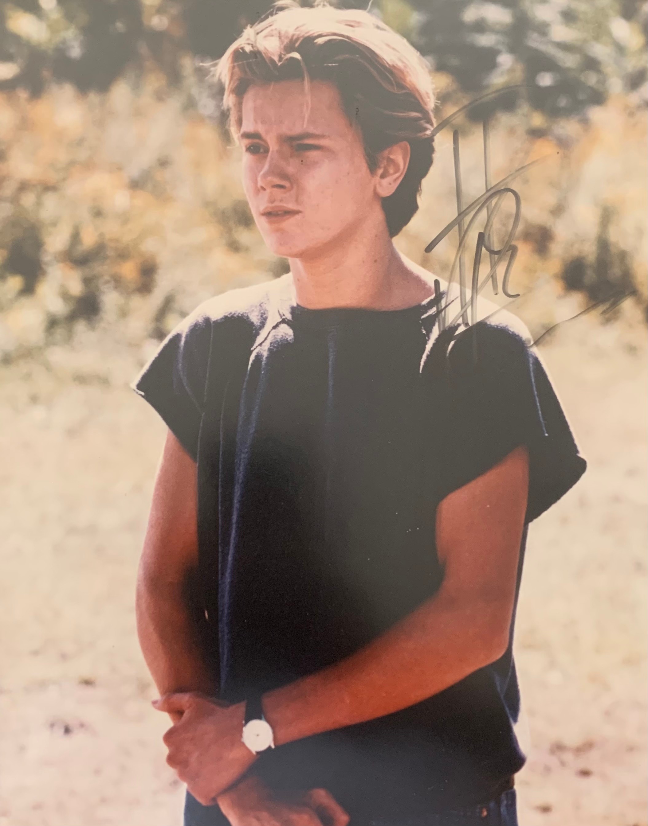River Phoenix (1970-1993) – A framed colour photograph signed by River Phoenix in black ink “River