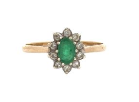 A 9ct gold emerald and diamond cluster ring, size Q. Oval emerald 6mm x 4mm. Ring weight 1.62g.