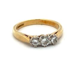 A hallmarked yellow 18ct gold and three stone diamond ring, size I. Diamond weight approx 0.3ct.