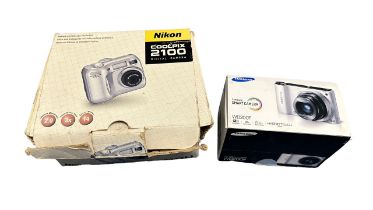 2x Digital Cameras. 1x Nikon Coolpix 2100 with original box,1x Samsung ST6 (wrong box)