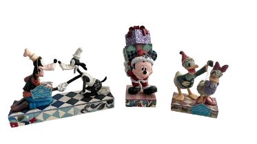 Jim Shore Disney Traditions; a group of three Jim Shore Disney Traditions Enensco figurines to