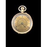 An open face pocket watch stamped 14K. Gold dial with foliate design and Roman numerals hour