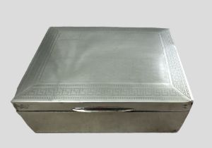 A George V rectangular silver box with wooden lining. Lid with geometric designed border. By S.