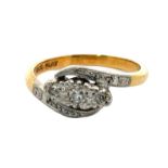 An early 20th century ring stamped '18ct gold and Plat' and set with three diamonds. Size I.