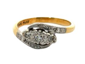 An early 20th century ring stamped '18ct gold and Plat' and set with three diamonds. Size I.