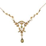 An Edwardian peridot and seed pearl pendant necklace stamped 14K on chain stamped 9ct. Overall