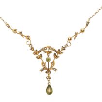 An Edwardian peridot and seed pearl pendant necklace stamped 14K on chain stamped 9ct. Overall