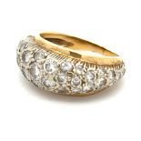 A gold ring set pave with diamonds, the largest of which is approx 02ct and has tiny chip on edge of
