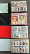 A collection of cigarette cards, mainly complete sets, sleeved in four albums, in good to