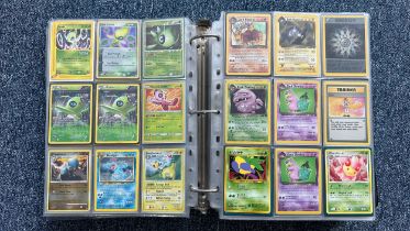 A folder containing duplicates of Pokemon cards. Various sets and series including Base Set, Ultra