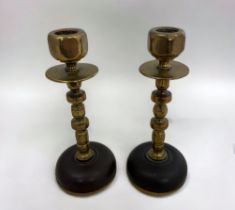 A pair of brass candlesticks with a nuts and bolts design. Height 16cm.