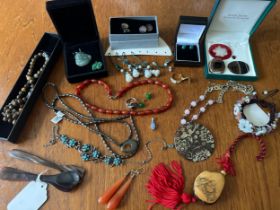 A number of pieces of hardstone and gem set jewellery, including a jade Buddha pendant, a tagua