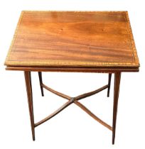 Edwardian lift and twist rectangular topped crossbanded satinwood games table, height 71cm, top 76.5