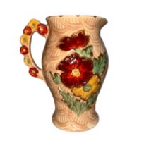 An Arthur Wood jug with raised floral design. Height 20cm