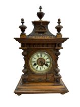 An oak mantel clock with enamelled dial, with paper label to interior H.A.C. 14 day strike made in