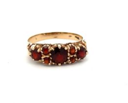 A 9ct gold and garnet ring, size M. Weight 1.94g Please see the buyer's terms and conditions for