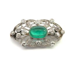 A green paste and old cut diamond platinum brooch with a yellow metal pin. Estimated diamond