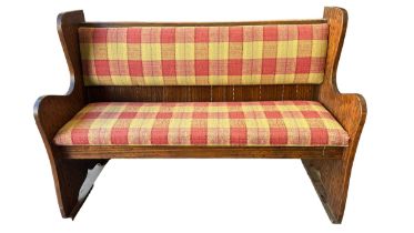 A Cotswold school style upholstered settle. Width 138cm.