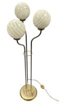 Mid 20th Century European glass globe floor lamp, with three brass standing arms and glass globe